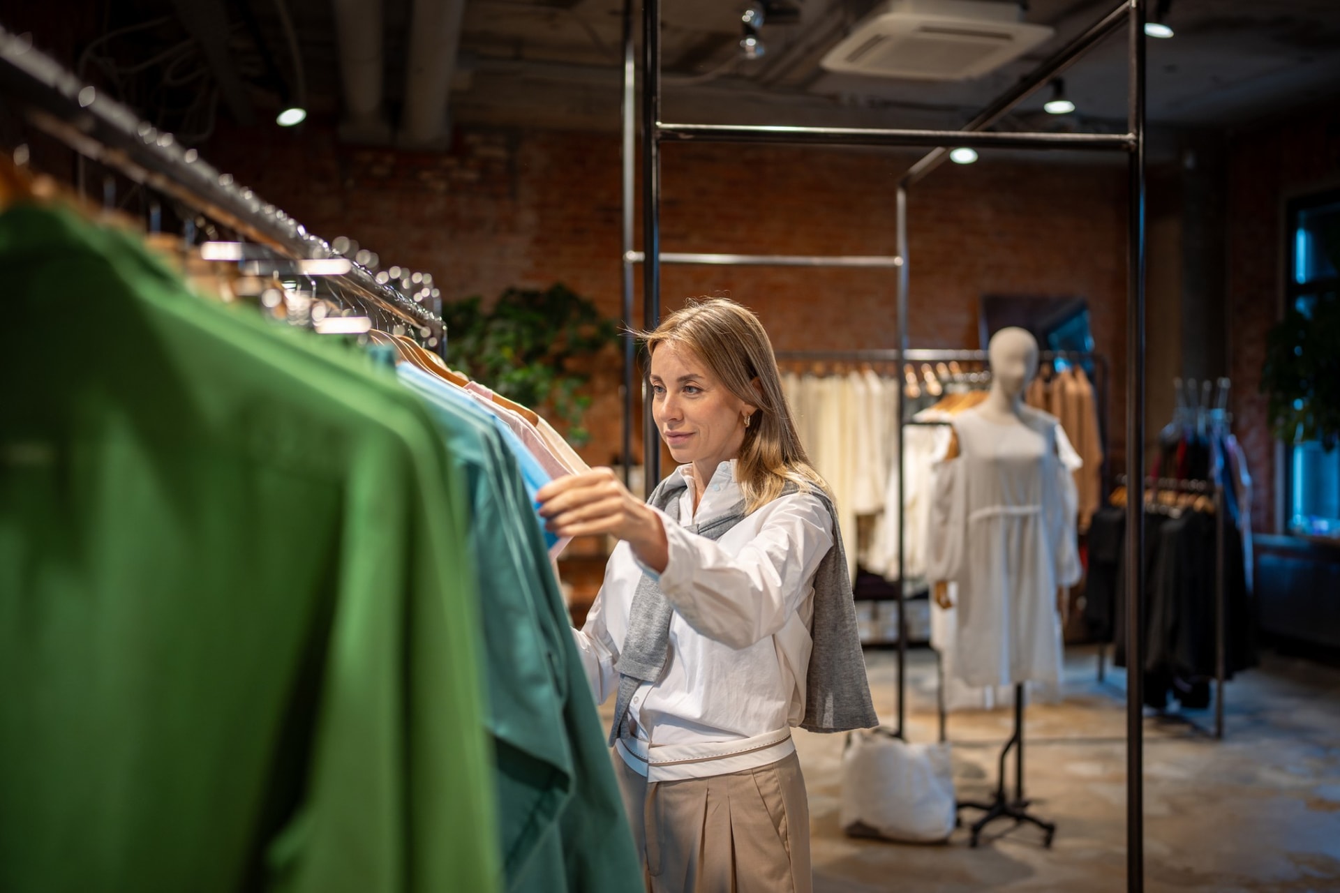 Fashion retailer checking stock on a rack, South Yarra VIC